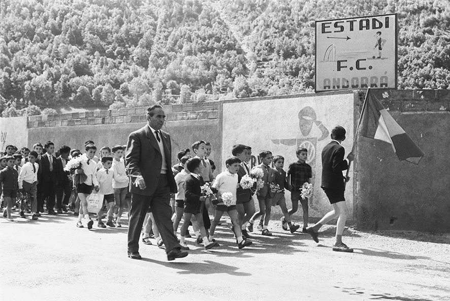 36_FAM_5110_03: Grup de nens amb rams de grandalles entrant a l’estadi del FC Andorra