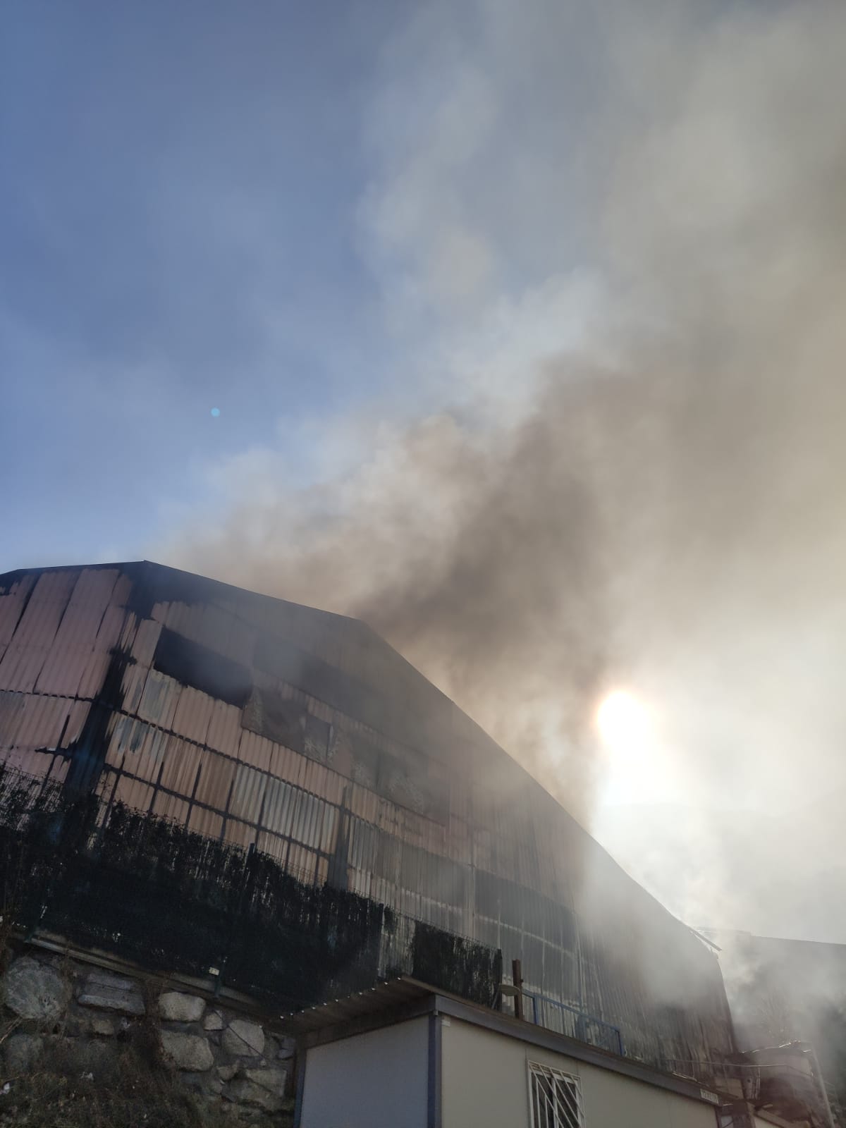 Els Bombers extingeixen un incendi a una nau industrial a la Comella
